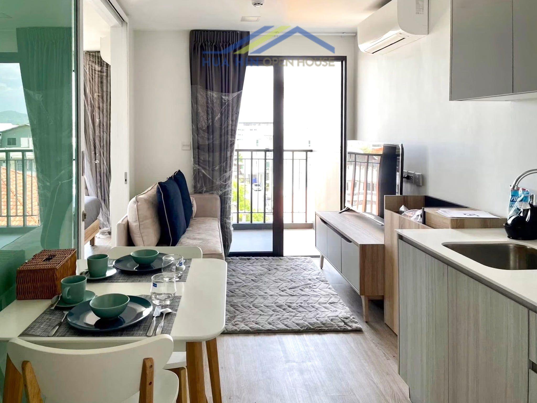 Bright corner unit condo featuring a cozy living area, dining space, and modern kitchen in Hua Hin Town Center.