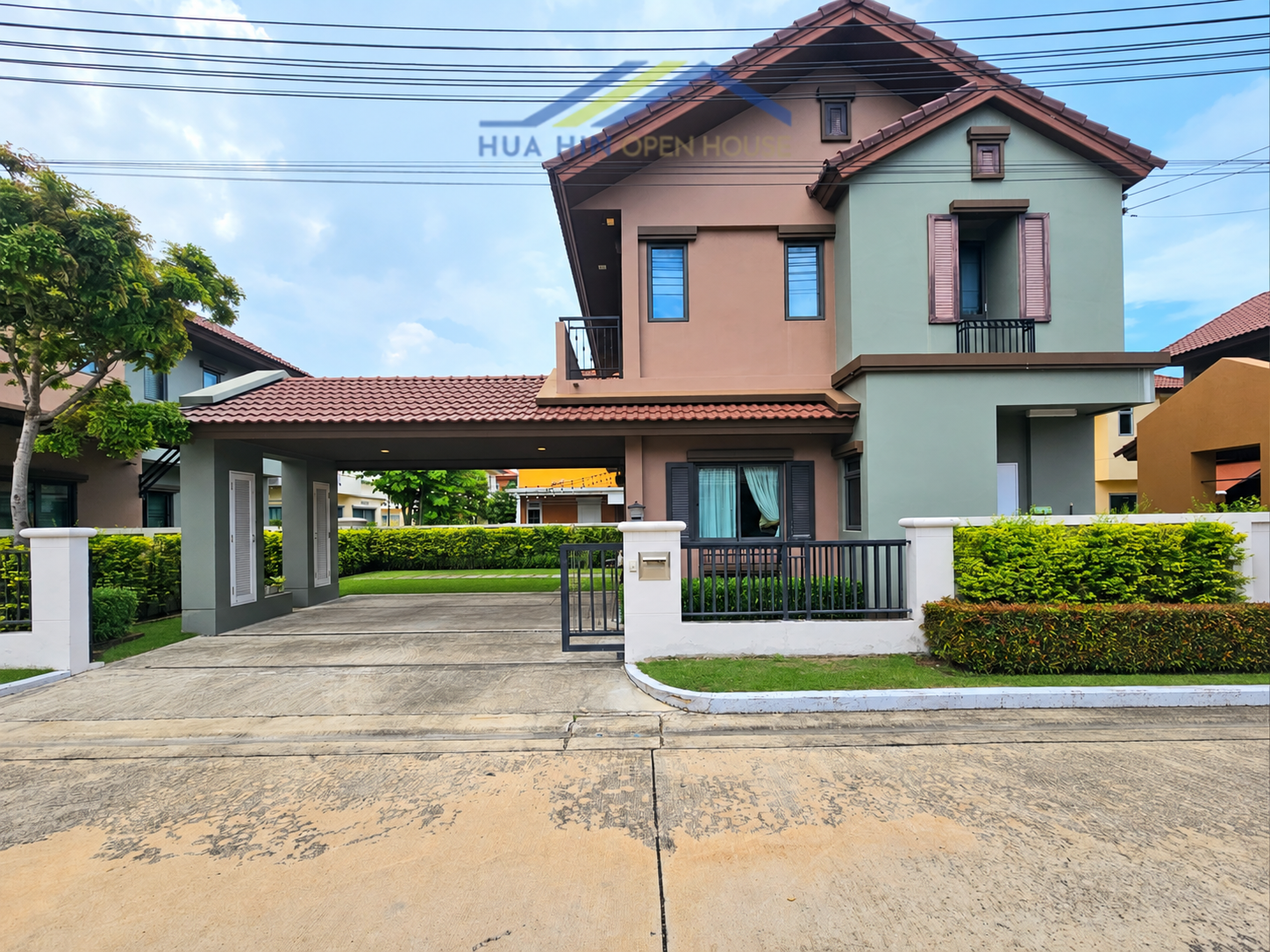 Stylish 3-bedroom seaside villa with a welcoming entrance, lush greenery, and modern architecture in Cha-Am.