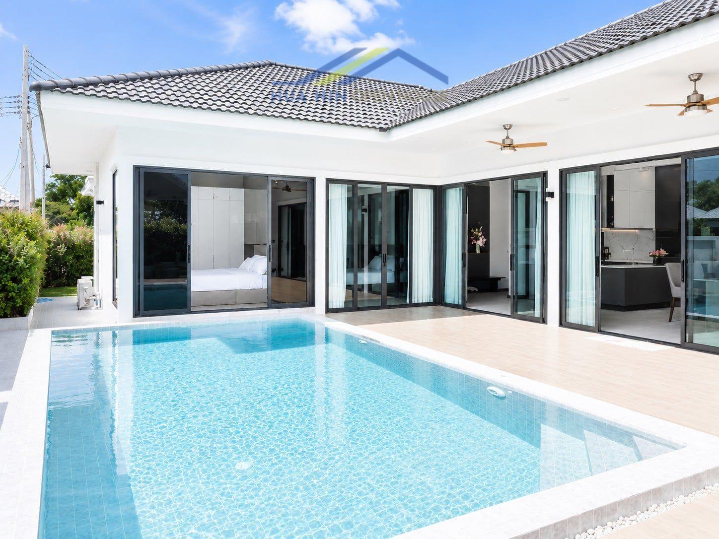Stylish 3-bedroom villa with a private pool, large glass doors, and modern design, surrounded by lush greenery.