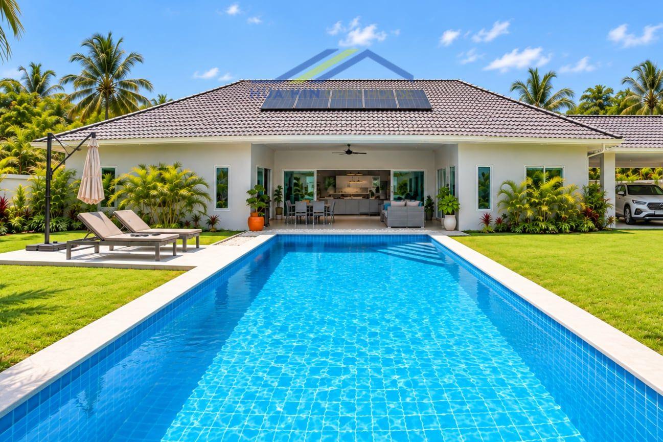 Customizable 4-bedroom villa with a private pool, lush garden, and outdoor seating area in Hua Hin, Thailand.
