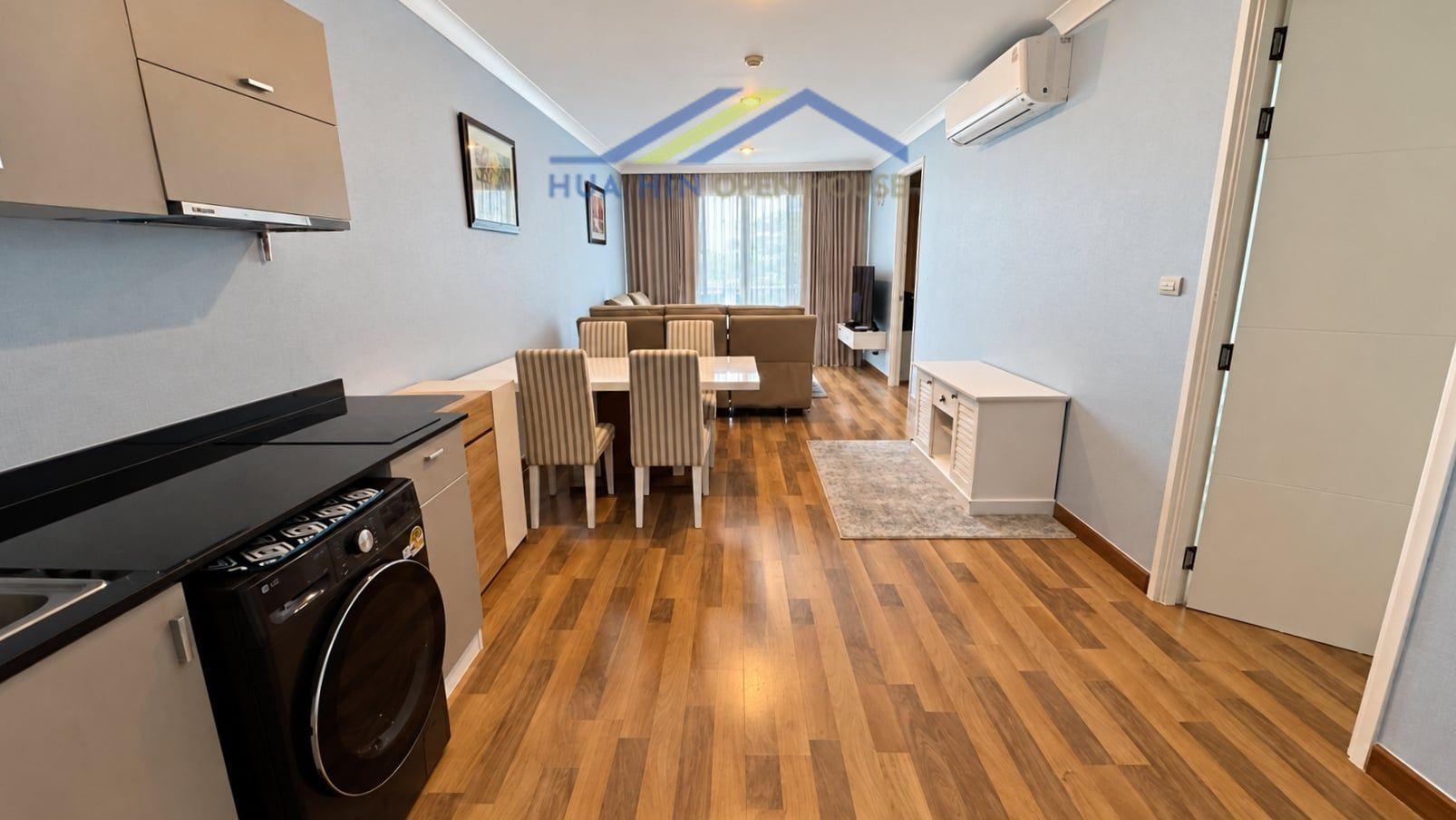 Spacious 2-bedroom condo interior featuring a modern kitchen, dining area, and living space with natural light.