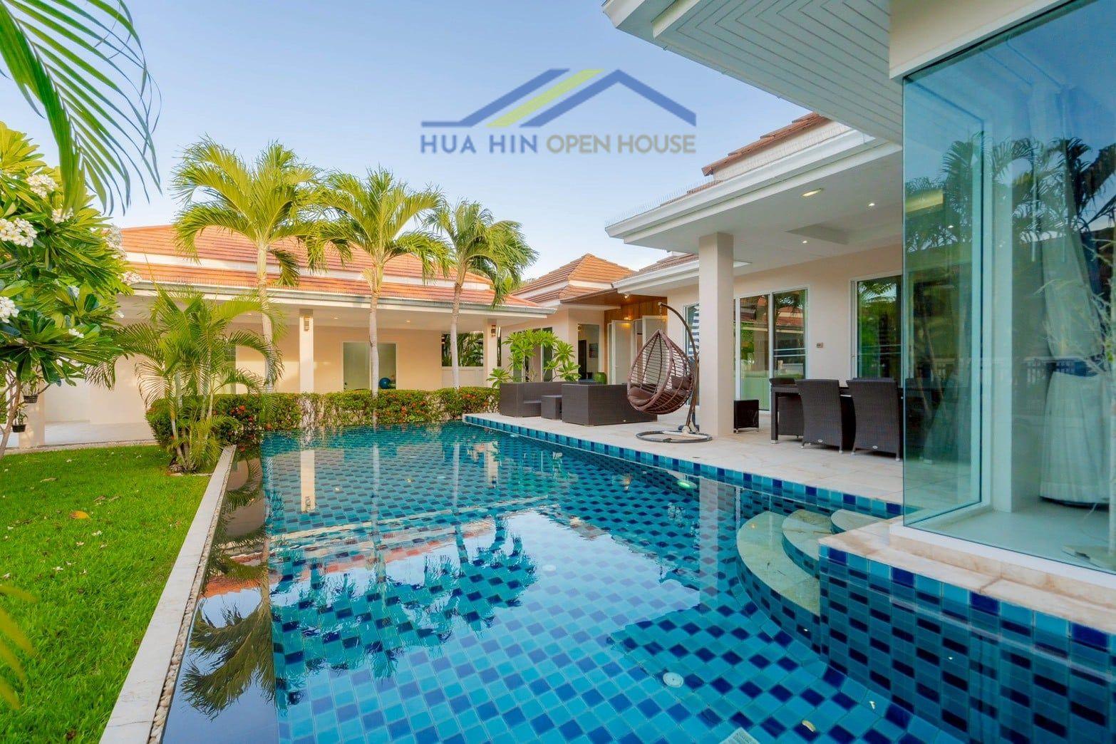 Spacious upgraded 4-bedroom villa with a private pool, large garden, and modern outdoor seating area in Hua Hin.