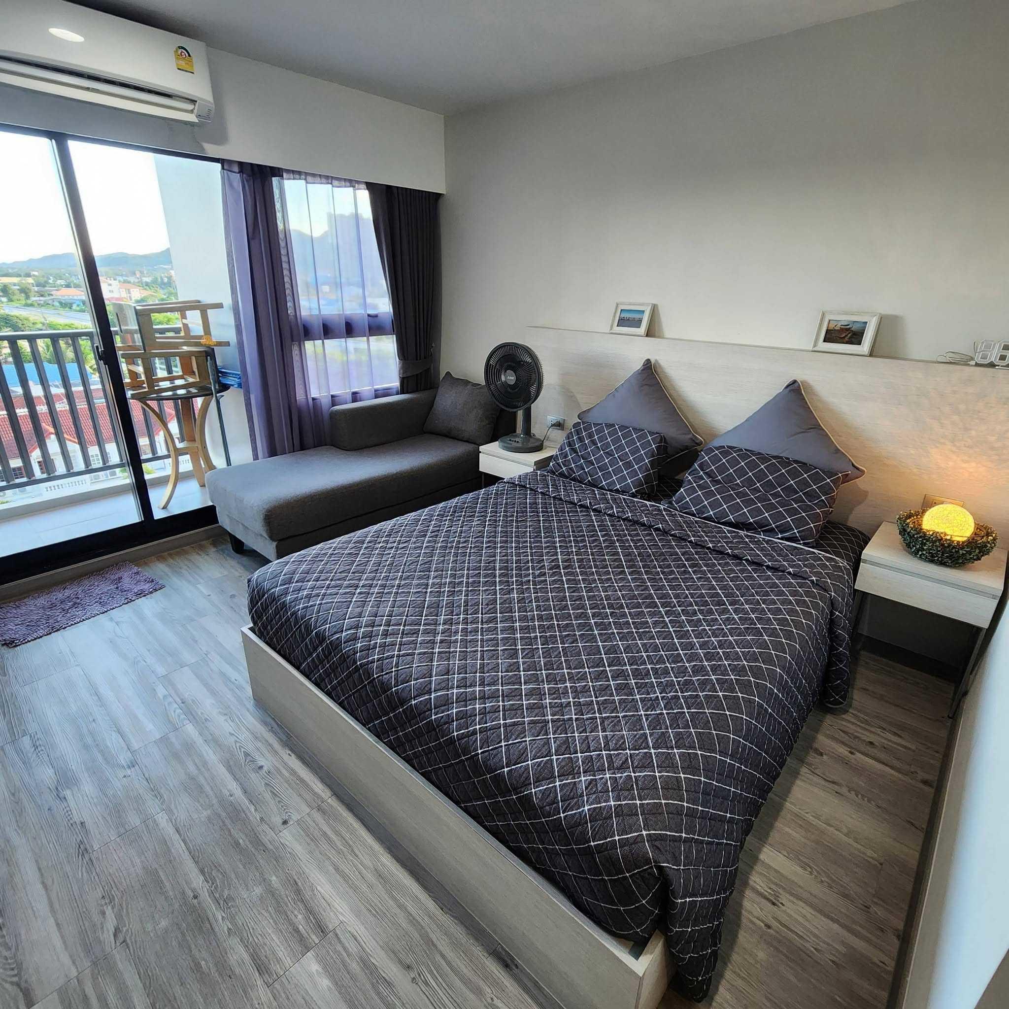 Cozy studio condo featuring a double bed, seating area, and balcony with mountain views in Dusit D2 Hua Hin.