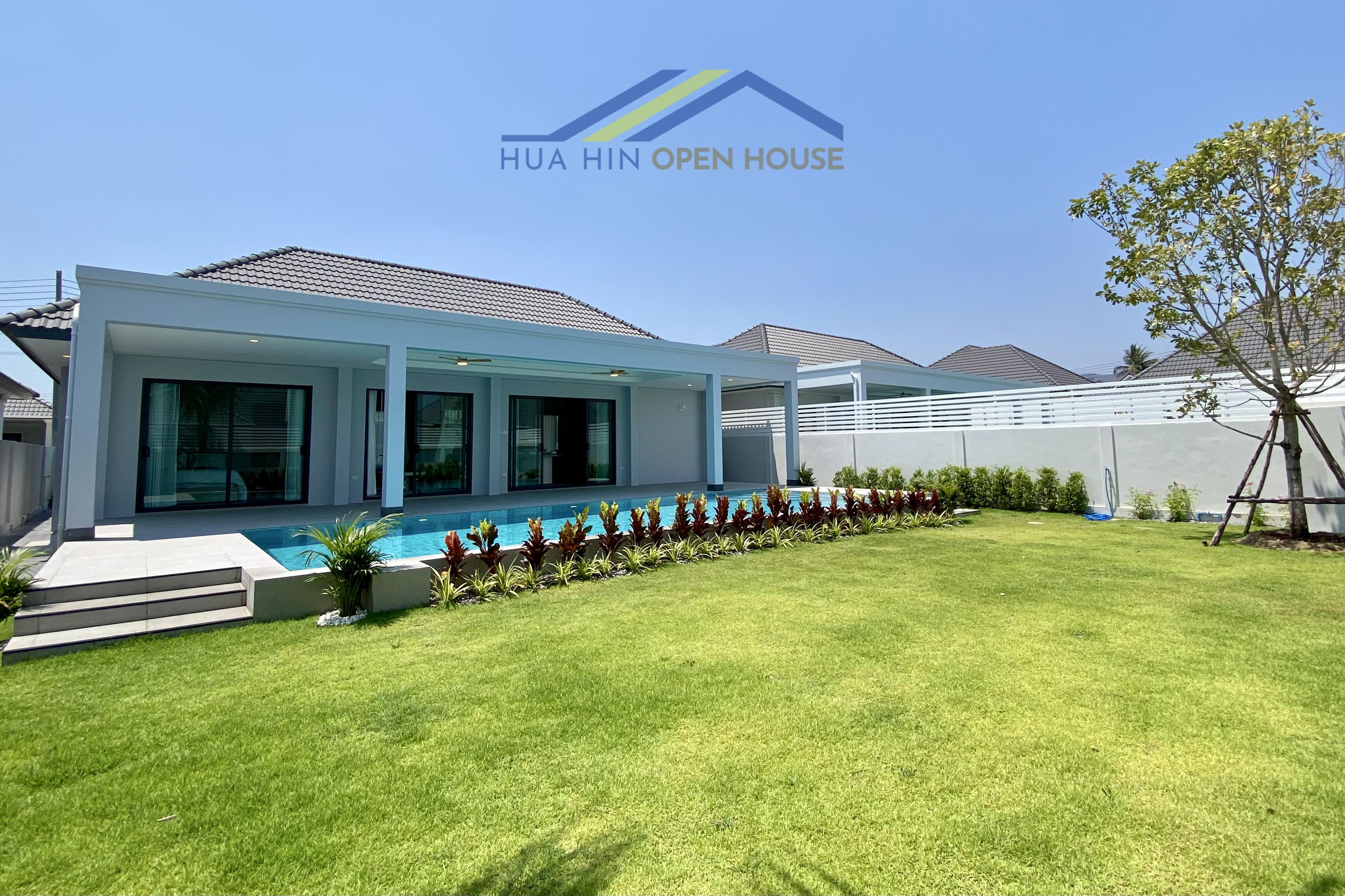 Modern pool villa with a spacious garden, featuring a sleek design and lush greenery in Sam Phraya, Hua Hin.