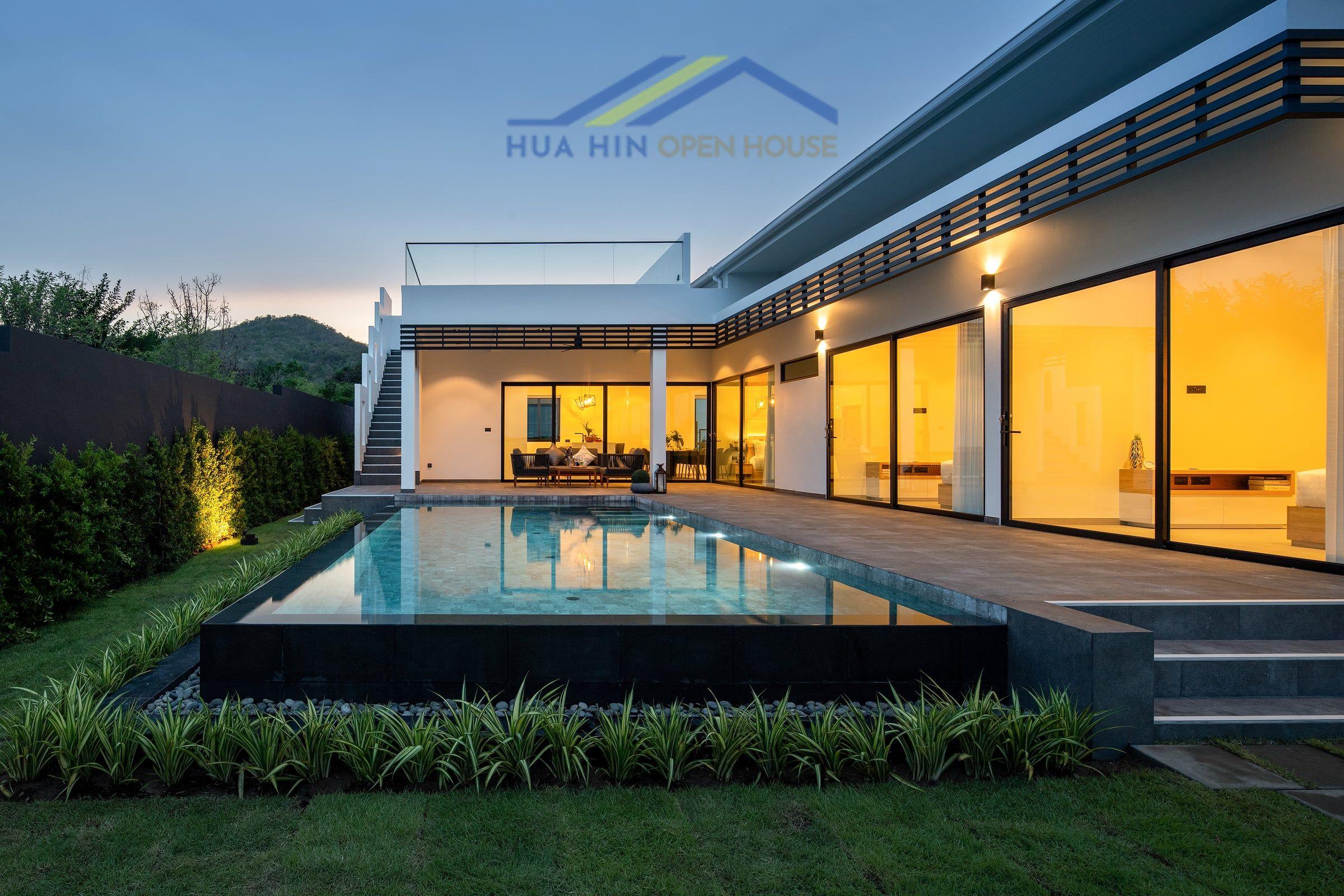 Modern pool villa with spacious terrace, lush landscaping, and mountain views in Sivana Villas, Hua Hin.