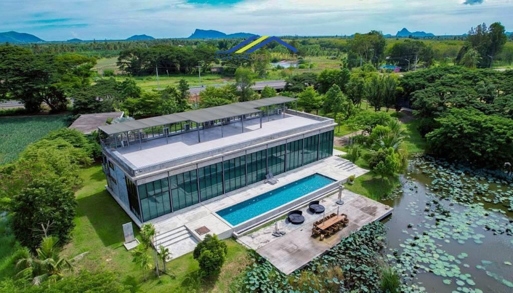 Aerial view of 17-Rai luxury estate in Prachuap Khiri Khan featuring a private lake, lotus pond, and 1,408 sqm mansion with mountain views03