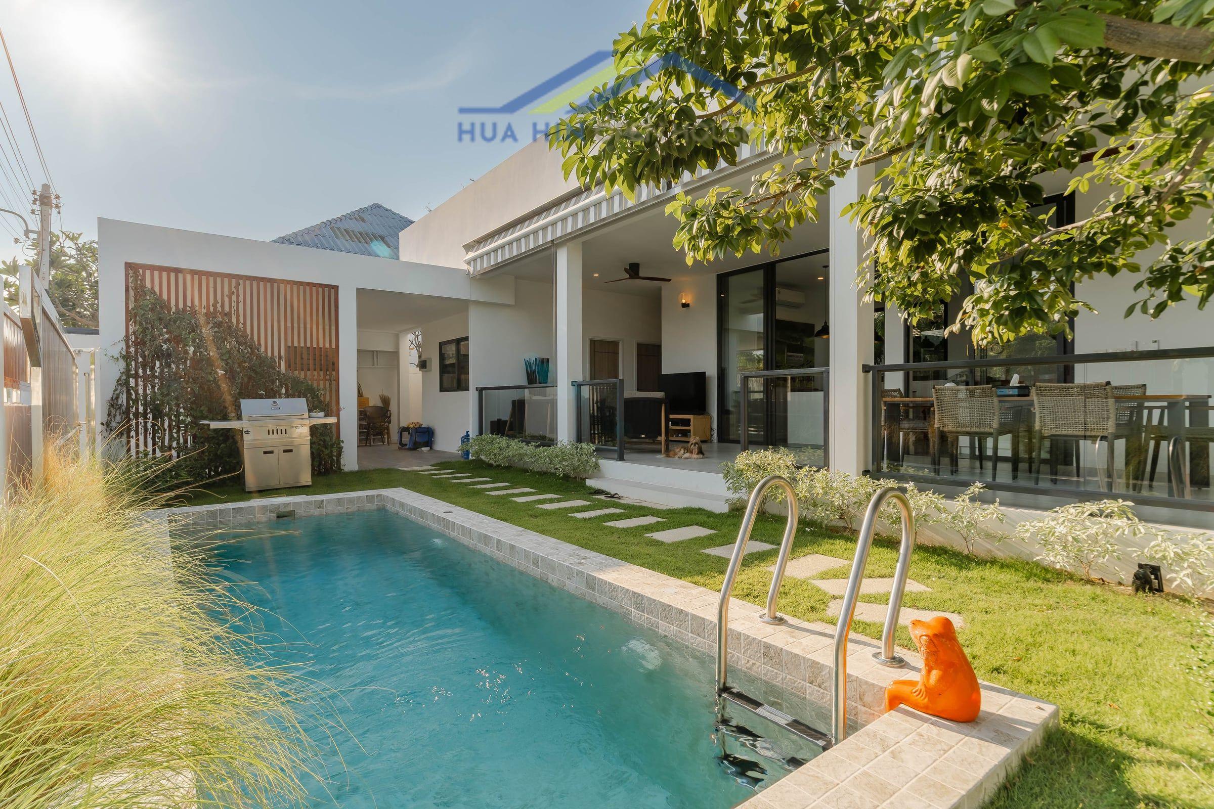 Modern 3-bedroom villa with private pool, outdoor dining area, and lush garden in Hua Hin Soi 114.