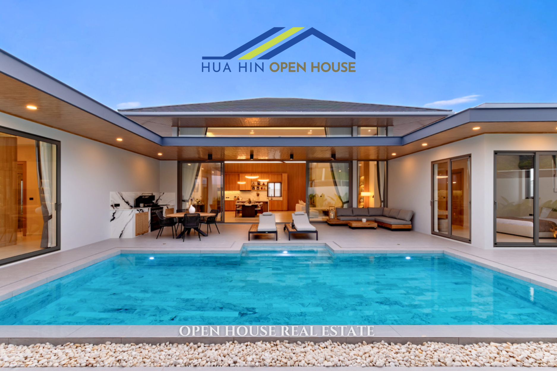 Modern luxury villa with a private pool, outdoor seating, and open living area in Hua Hin, Thailand.