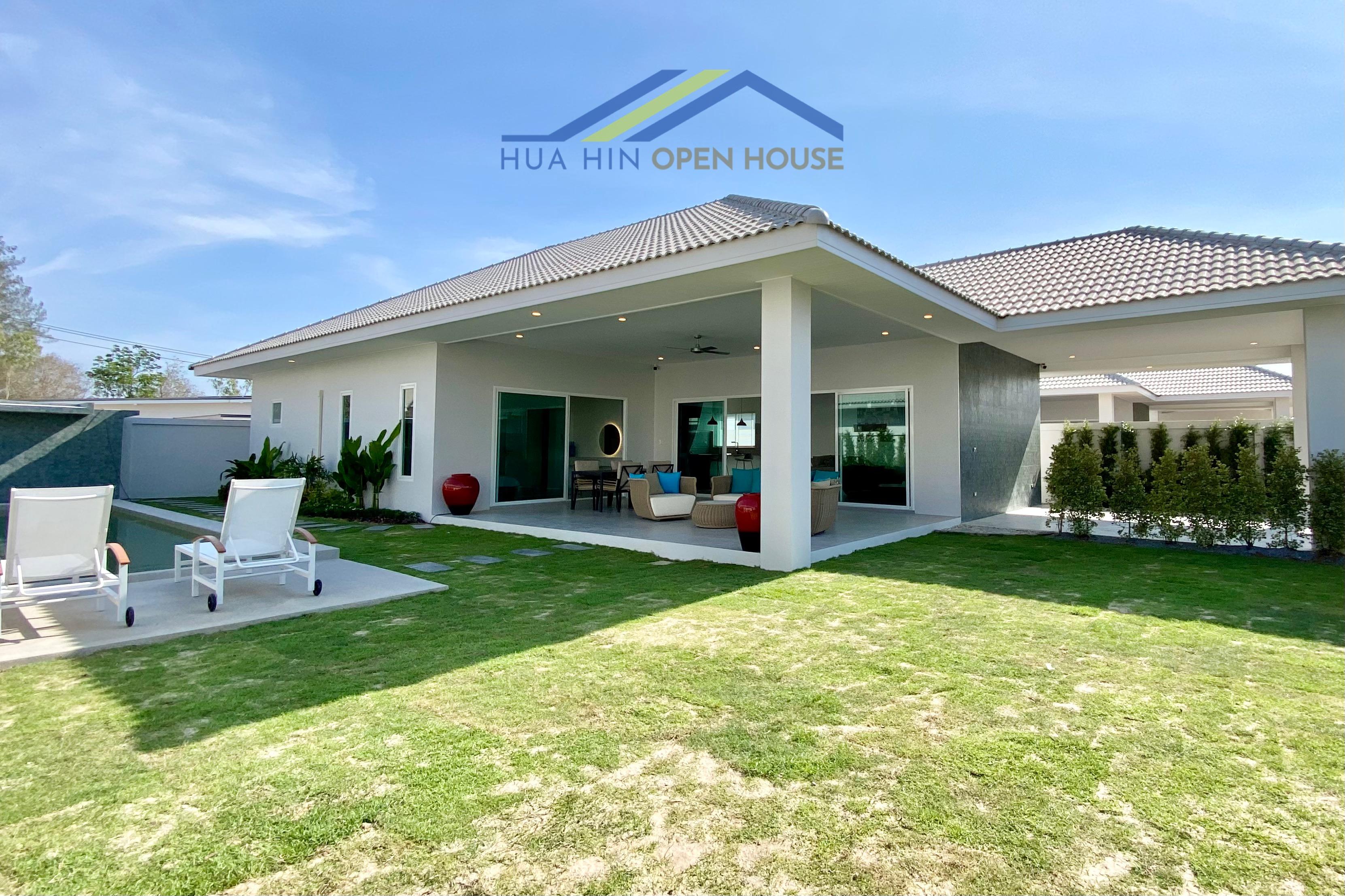 Modern 3-bedroom pool villa in Hua Hin with a 4x10m pool, spacious lawn, and outdoor seating area.