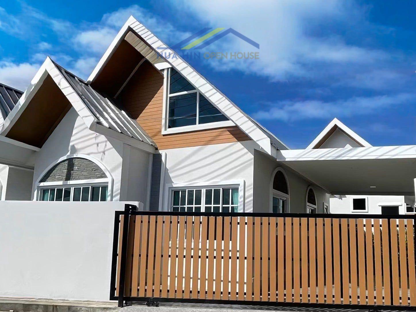 Modern 2-bedroom villa with a stylish facade, featuring a wooden gate and a clear blue sky backdrop in Hua Hin.