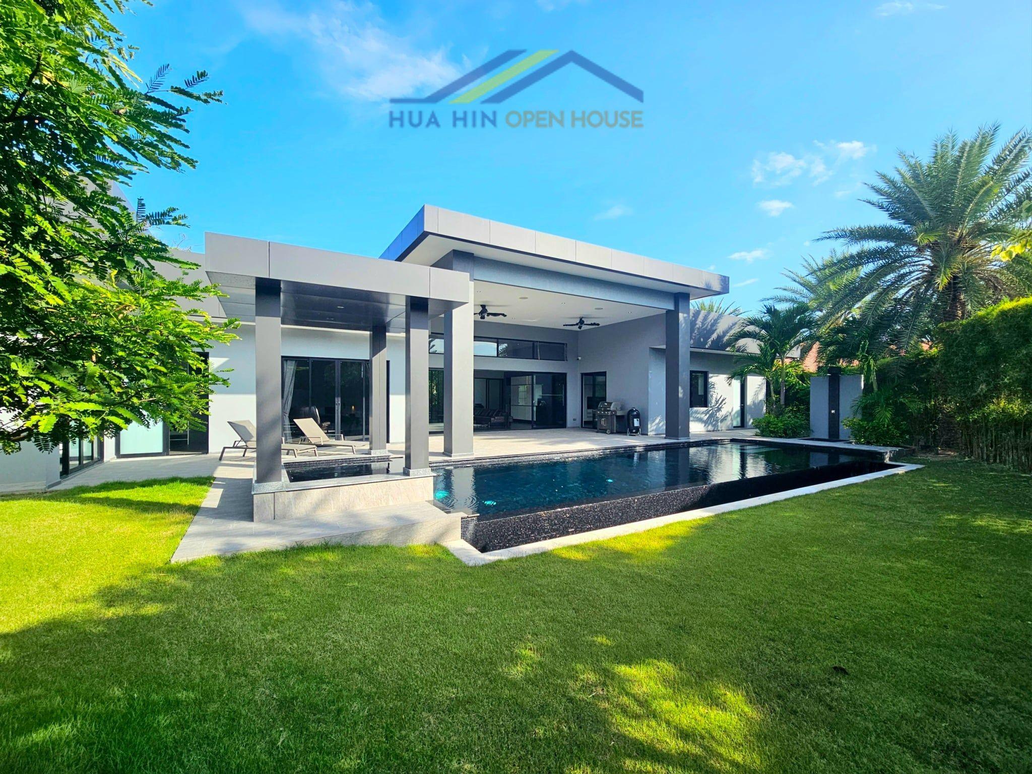 Modern luxury villa with a private pool, lush garden, and stylish outdoor seating area in Hua Hin.